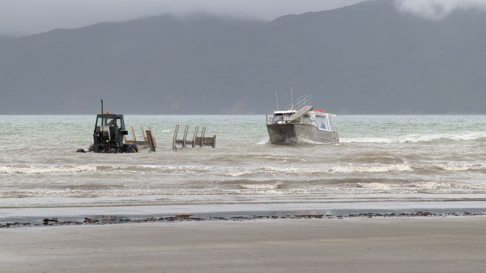Kapiti Island Nature Tours boat on Paraparaumu beach Kapiti Island Nature Tours boat docking on Paraparaumu beach with a tractor